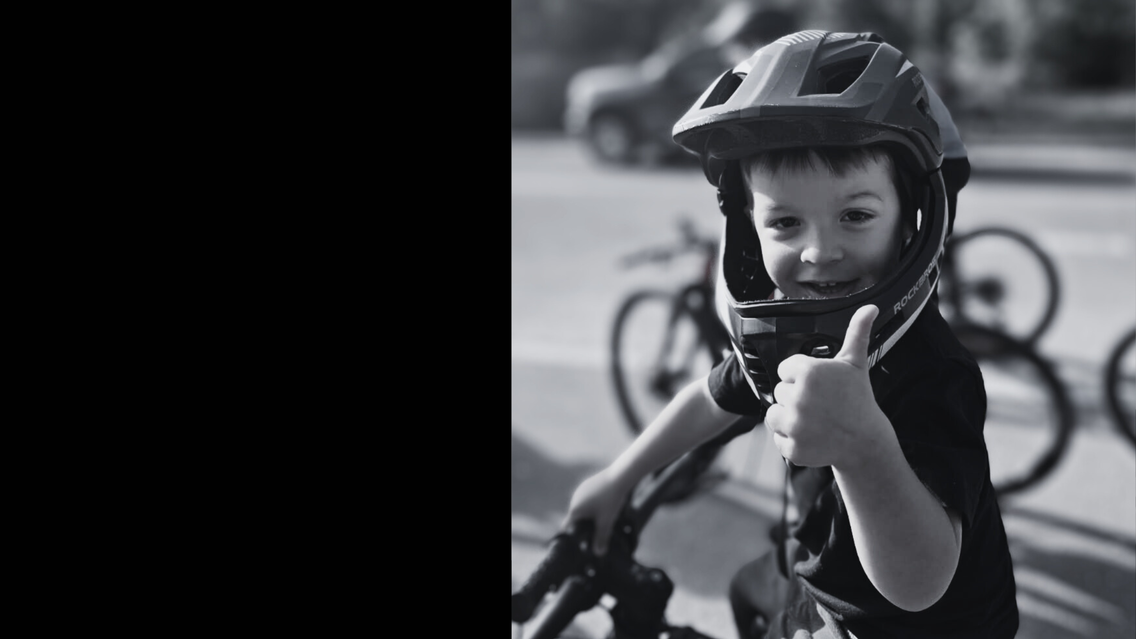 toddler boy riding balance bike giving thumbs up – adventure kids clothing by Wild Little Ones