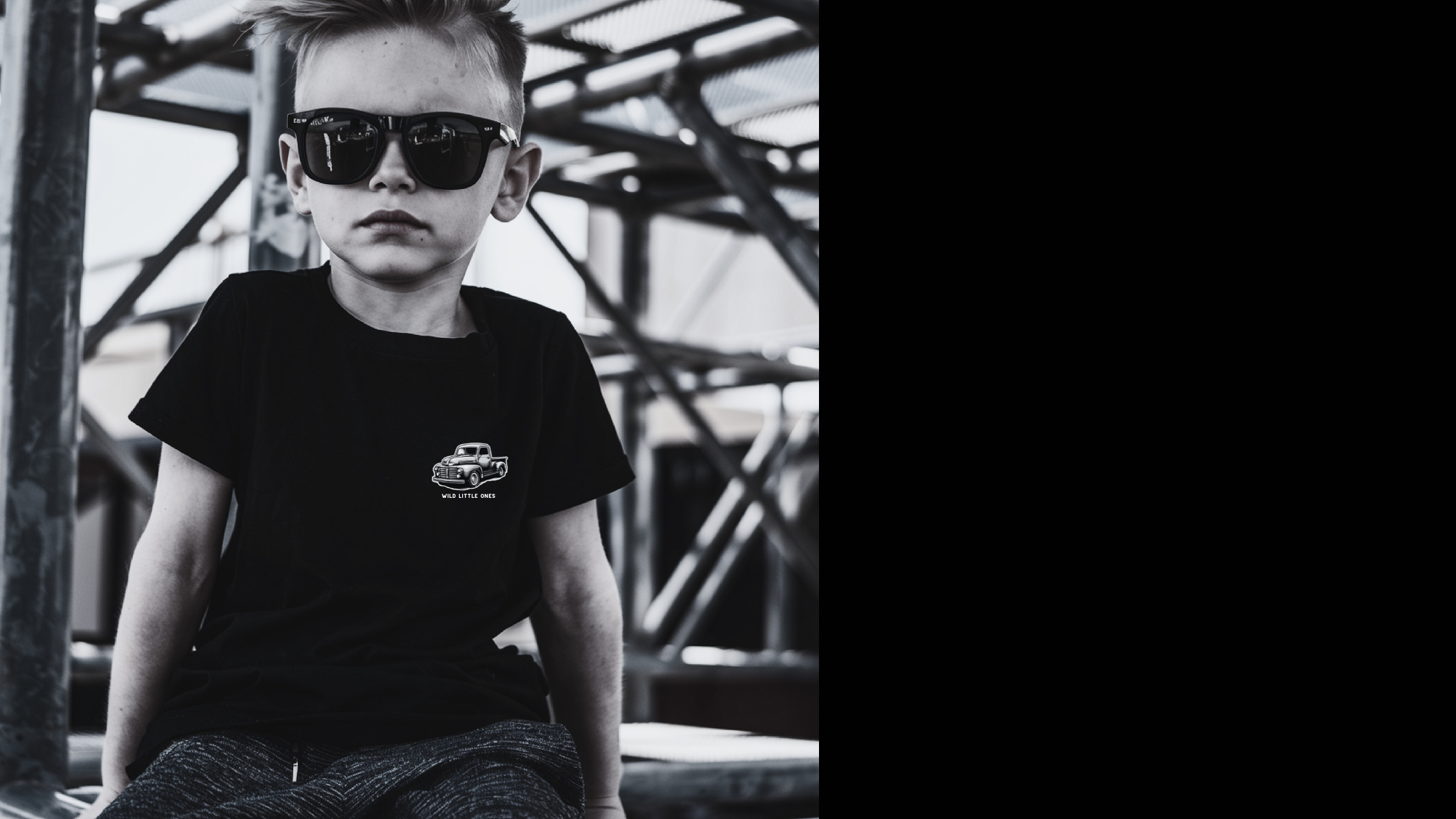 Rad toddler wearing sunglasses and Wild Little Ones truck graphic T-shirt – cool boys adventure clothing